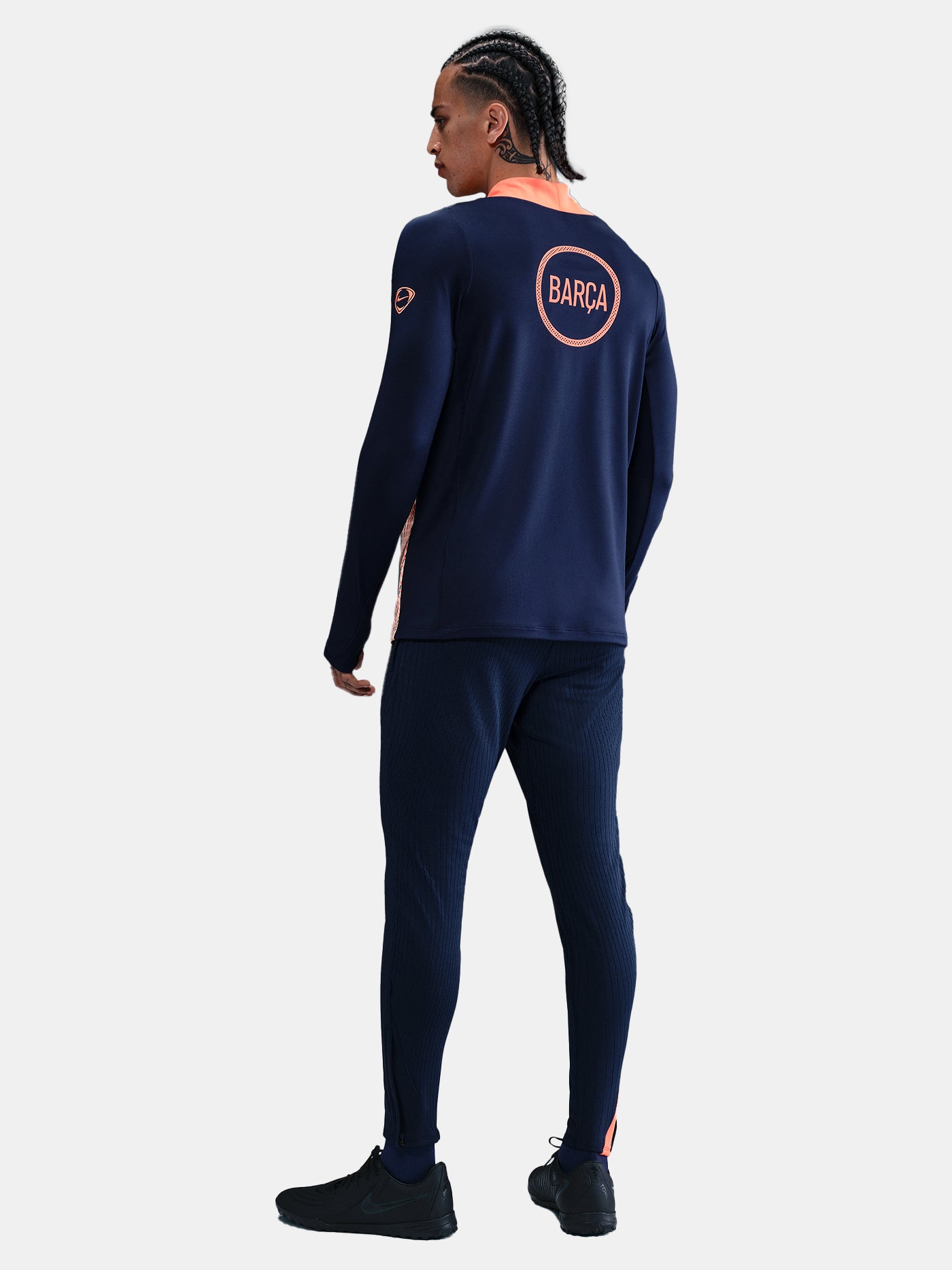 FC Barcelona navy long-sleeve training top with coral Nike logo, Spotify sponsor, and modern coral and white geometric pattern across the chest and shoulders.