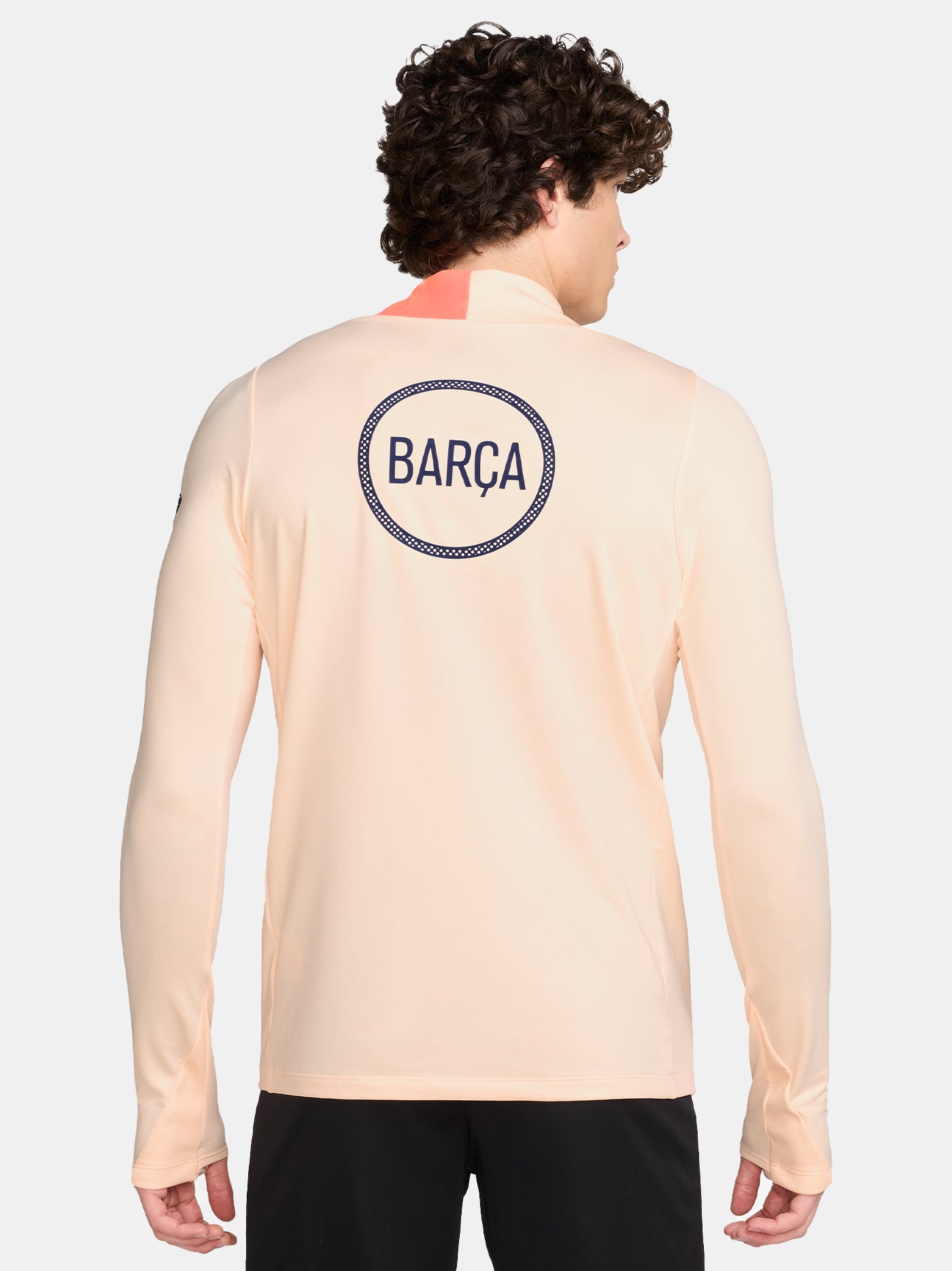 FC Barcelona long-sleeve peach training top with navy Nike logo, club crest, Spotify sponsor, and coral shoulder detail