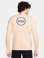 FC Barcelona long-sleeve peach training top with navy Nike logo, club crest, Spotify sponsor, and coral shoulder detail