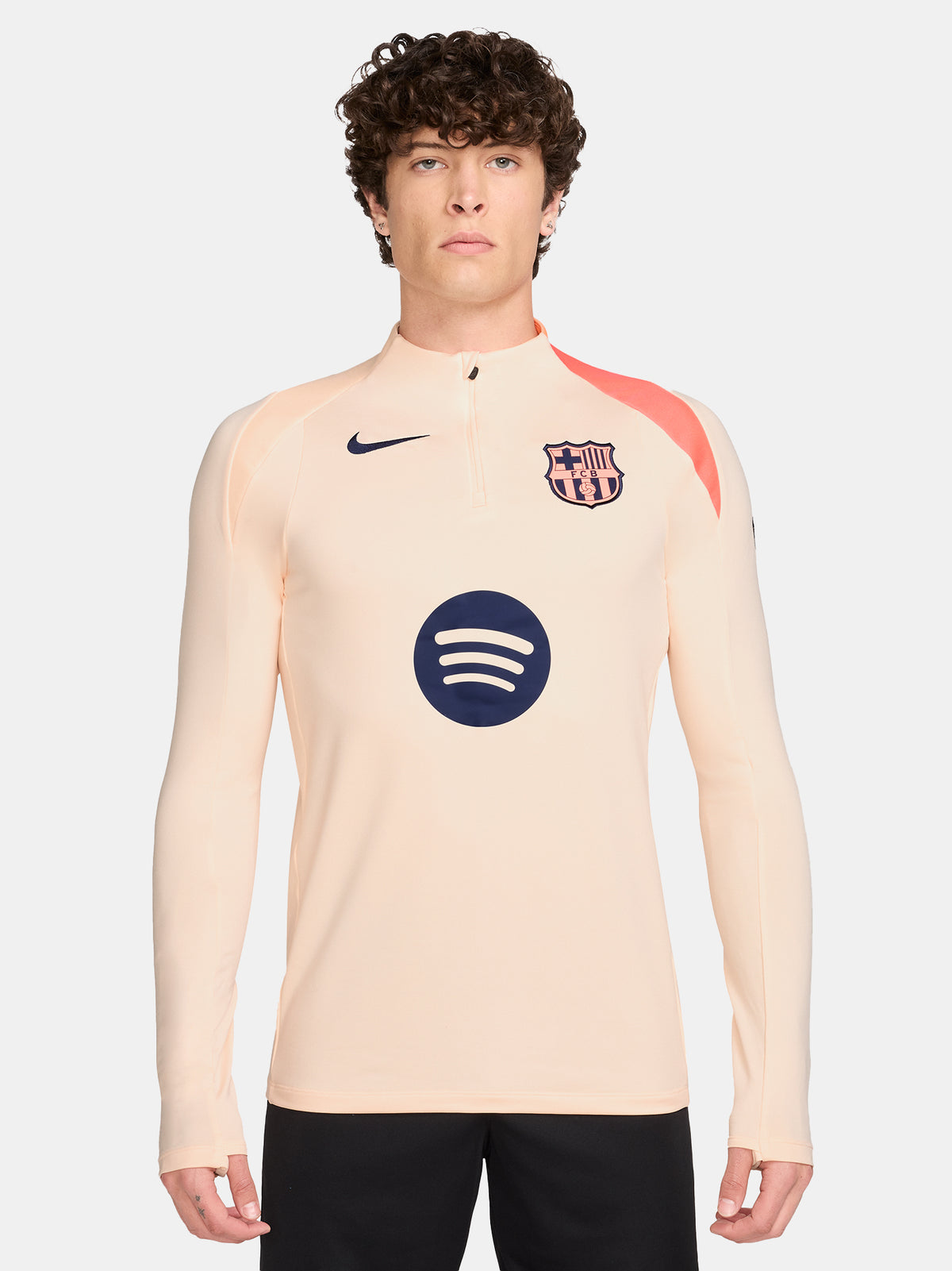 FC Barcelona long-sleeve peach training top with navy Nike logo, club crest, Spotify sponsor, and coral shoulder detail