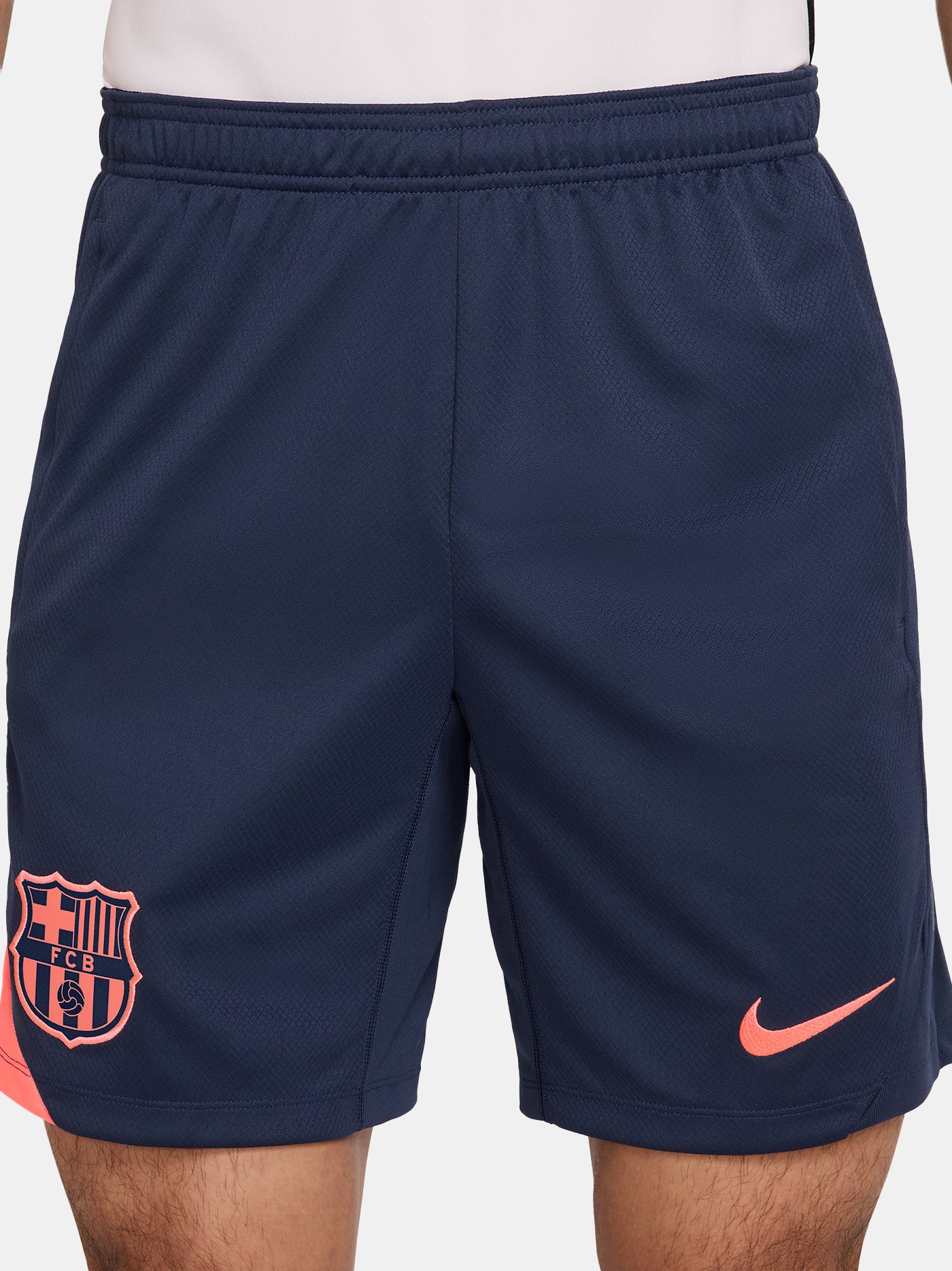 FC Barcelona navy blue training shorts with coral Nike logo and club crest