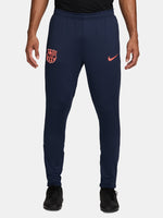 FC Barcelona navy blue training pants with slim fit, featuring the club crest and Nike logo in coral on the front