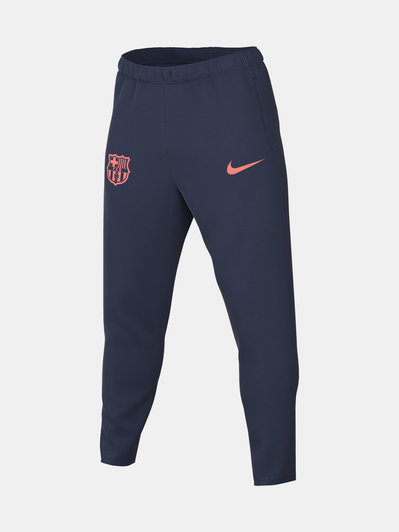 FC Barcelona navy blue training pants with slim fit, featuring the club crest and Nike logo in coral on the front