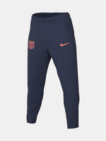 FC Barcelona navy blue training pants with slim fit, featuring the club crest and Nike logo in coral on the front