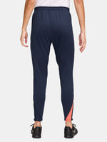 FC Barcelona navy blue training pants with slim fit, featuring the club crest and Nike logo in coral on the front