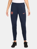 FC Barcelona navy blue training pants with slim fit, featuring the club crest and Nike logo in coral on the front