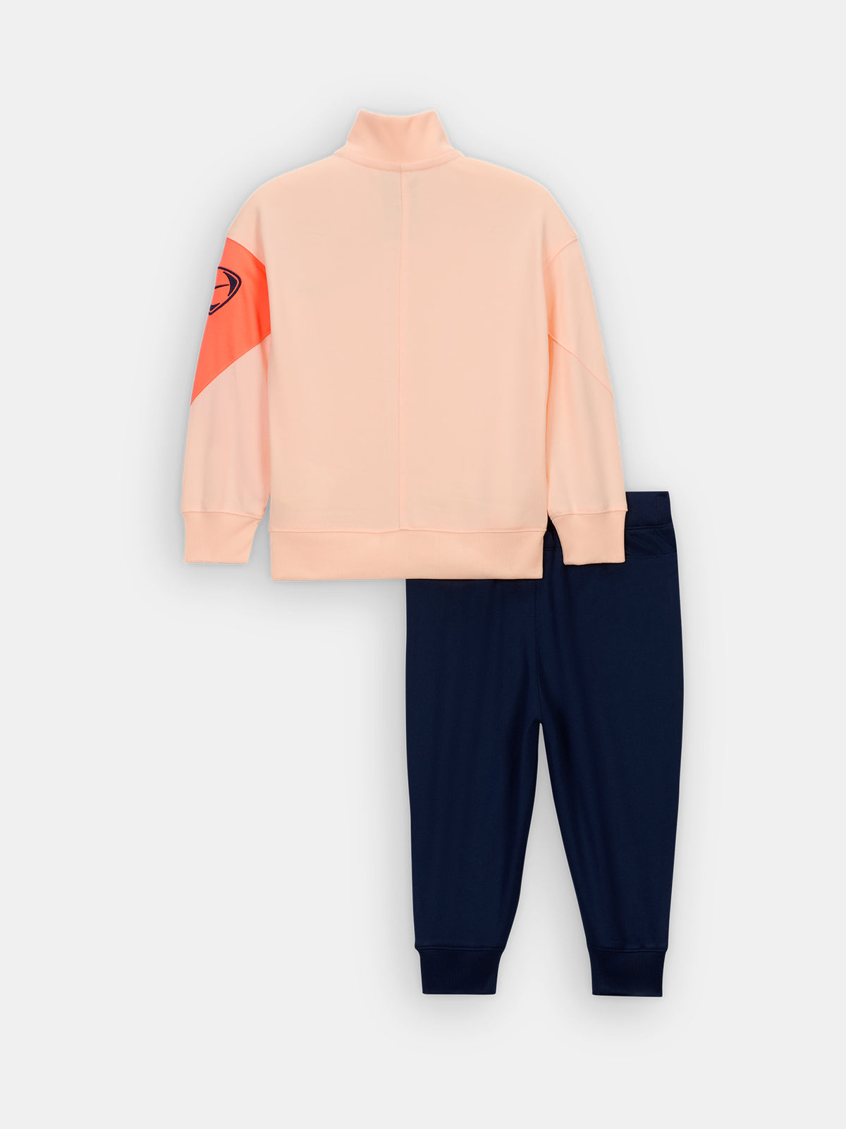 FC Barcelona Nike jacket with coral sleeve detail, paired with navy jogger pants featuring the club crest and Nike swoosh