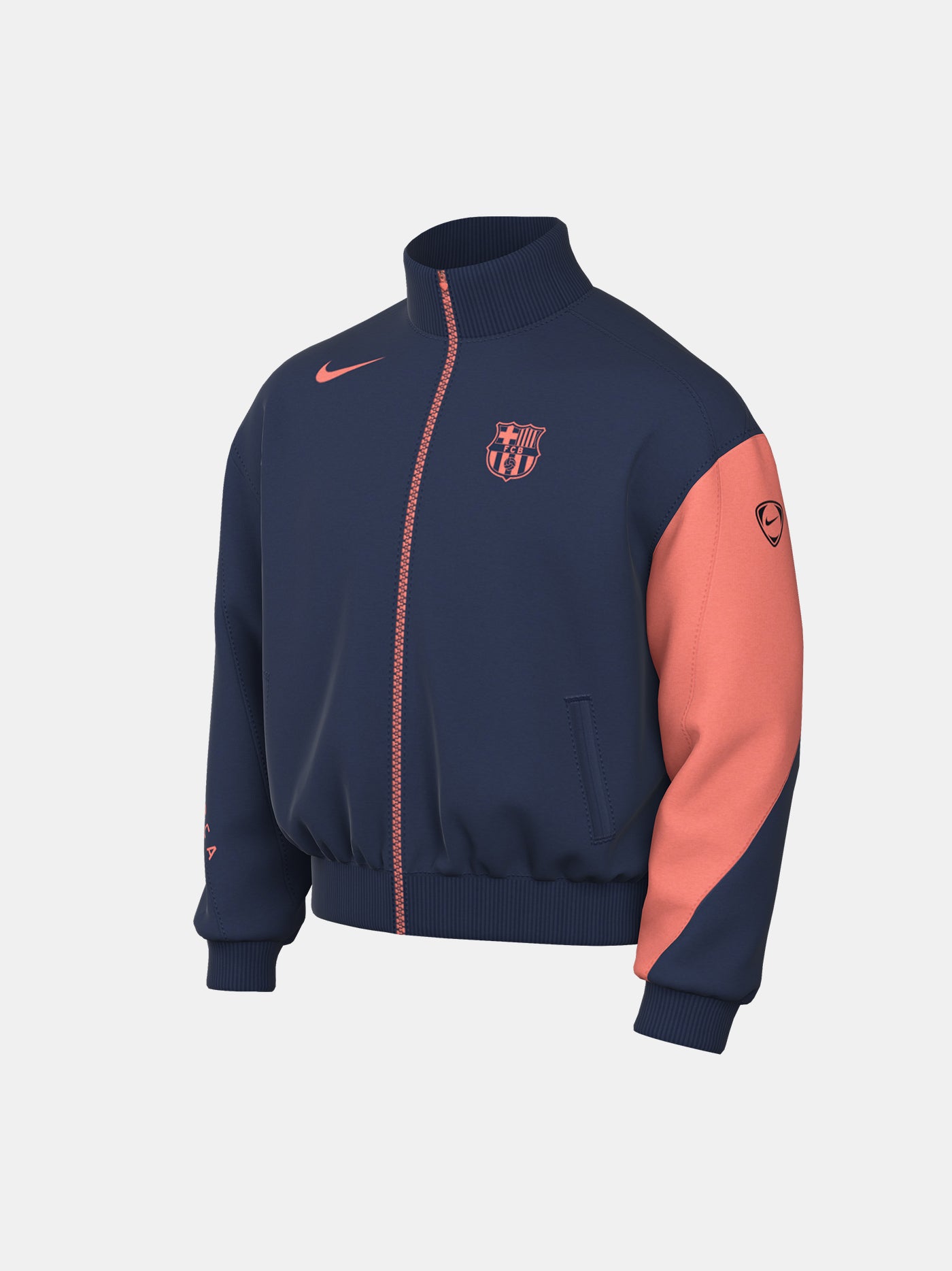 FC Barcelona navy blue jacket with coral details, including a coral sleeve, zipper, Nike logo, and club crest, paired with white Nike pants.