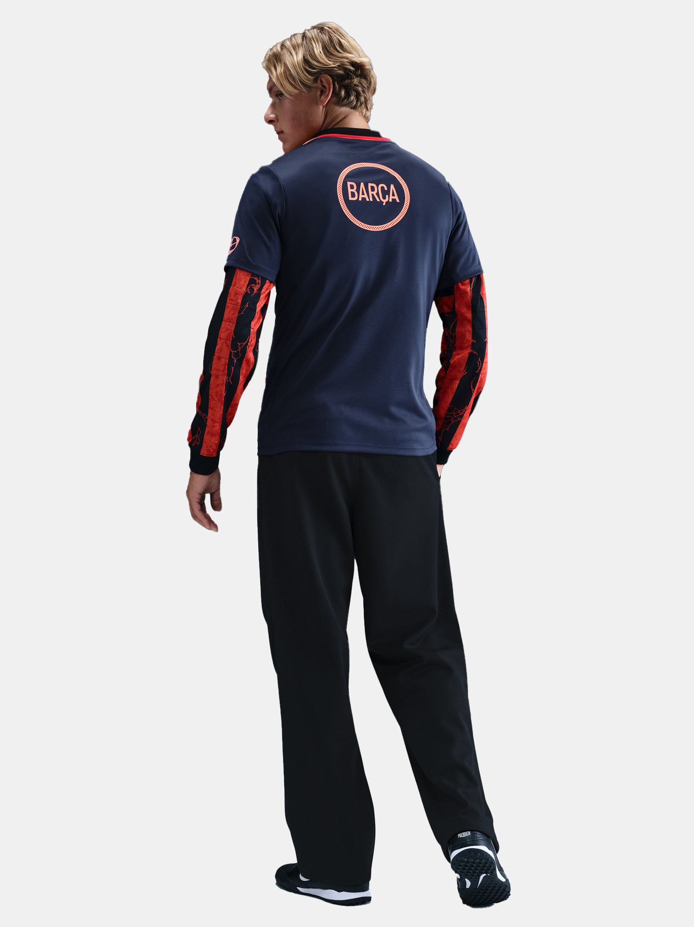 FC Barcelona navy training shirt with coral Nike logo, Spotify sponsor, and geometric coral and white pattern design on the shoulder and chest