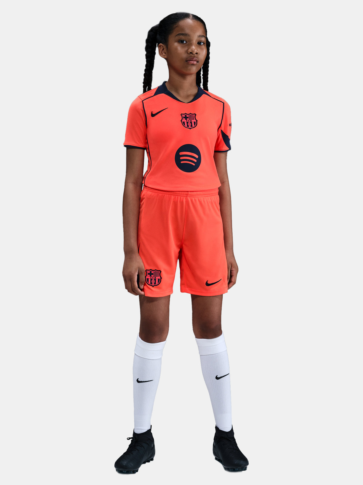 FC Barcelona third kit football shorts in orange with navy blue Nike logo and club crest