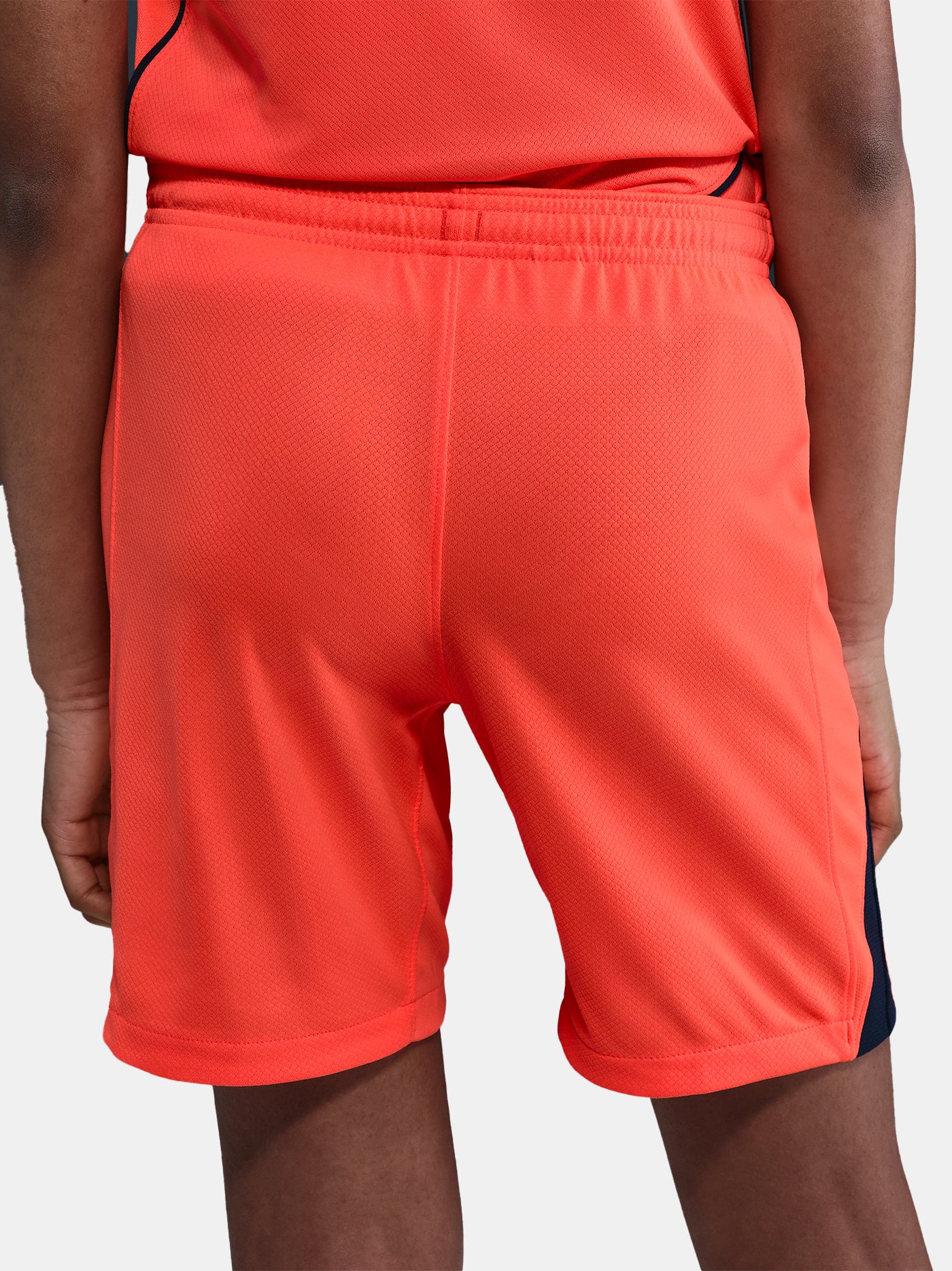 FC Barcelona third kit football shorts in orange with navy blue Nike logo and club crest
