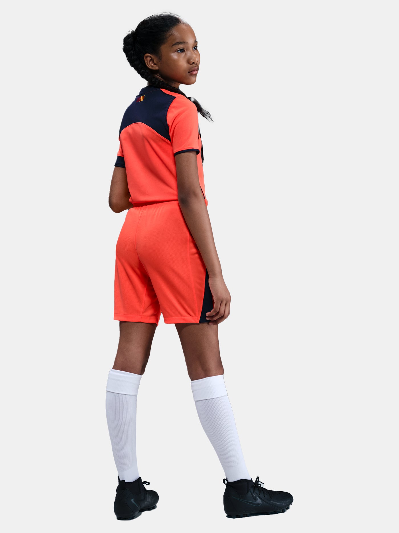FC Barcelona third kit football shorts in orange with navy blue Nike logo and club crest