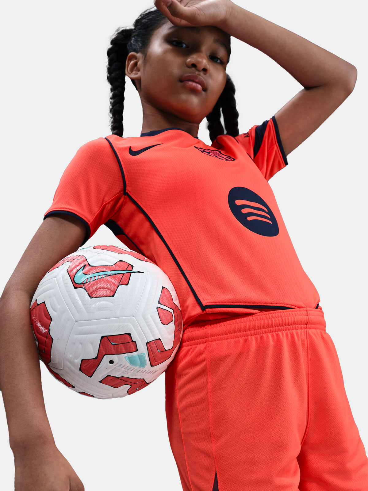 FC Barcelona third kit football shorts in orange with navy blue Nike logo and club crest