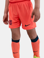 FC Barcelona 2025/26 third kit for kids in orange with navy blue details, including shirt, shorts, and socks.