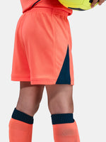 FC Barcelona 2025/26 third kit for kids in orange with navy blue details, including shirt, shorts, and socks.