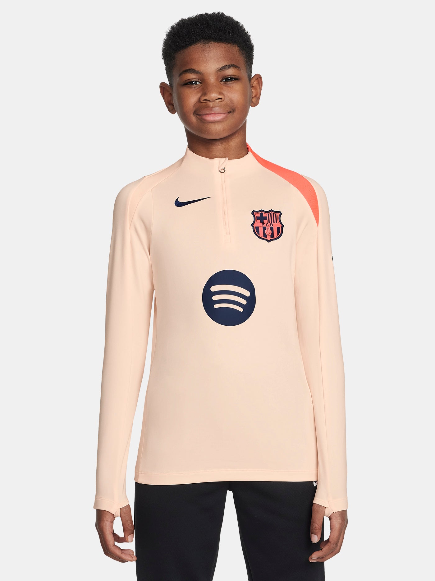 FC Barcelona long-sleeve peach training top with navy Nike logo, club crest, Spotify sponsor, and coral shoulder detail