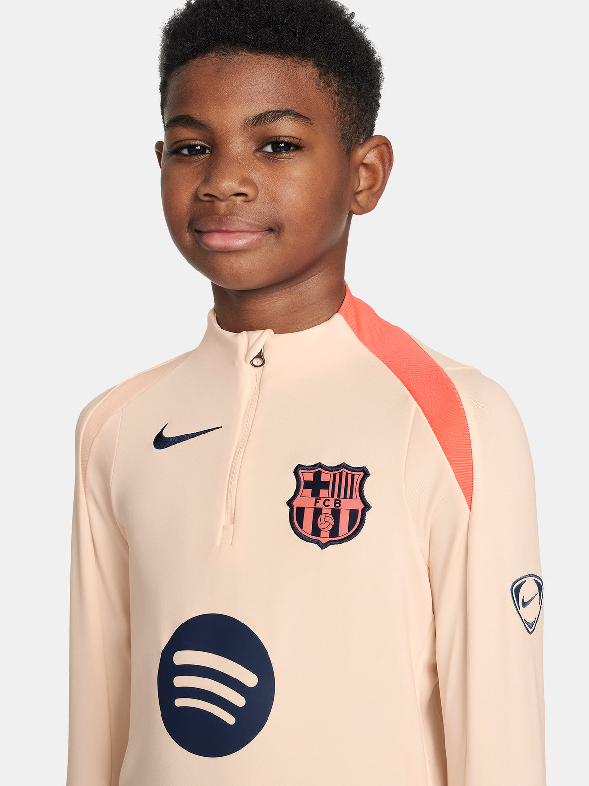 FC Barcelona long-sleeve peach training top with navy Nike logo, club crest, Spotify sponsor, and coral shoulder detail