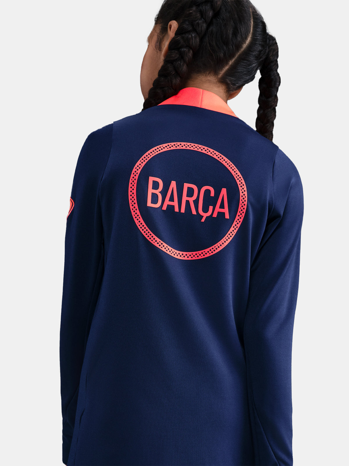 FC Barcelona navy training kit consisting of a long-sleeve top with coral Nike logo, Spotify sponsor and geometric design, paired with matching navy shorts featuring coral accents and the club crest.