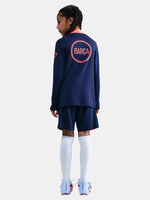FC Barcelona navy training kit consisting of a long-sleeve top with coral Nike logo, Spotify sponsor and geometric design, paired with matching navy shorts featuring coral accents and the club crest.