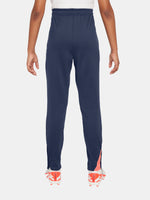 FC Barcelona navy blue training pants with slim fit, featuring the club crest and Nike logo in coral on the front