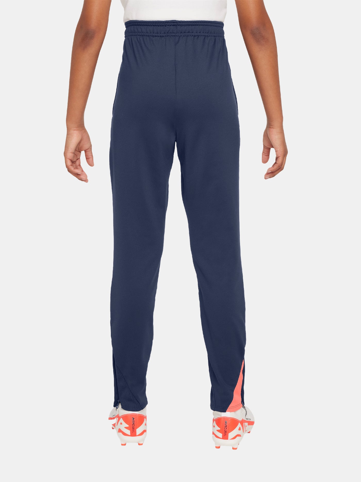 FC Barcelona navy blue training pants with slim fit, featuring the club crest and Nike logo in coral on the front