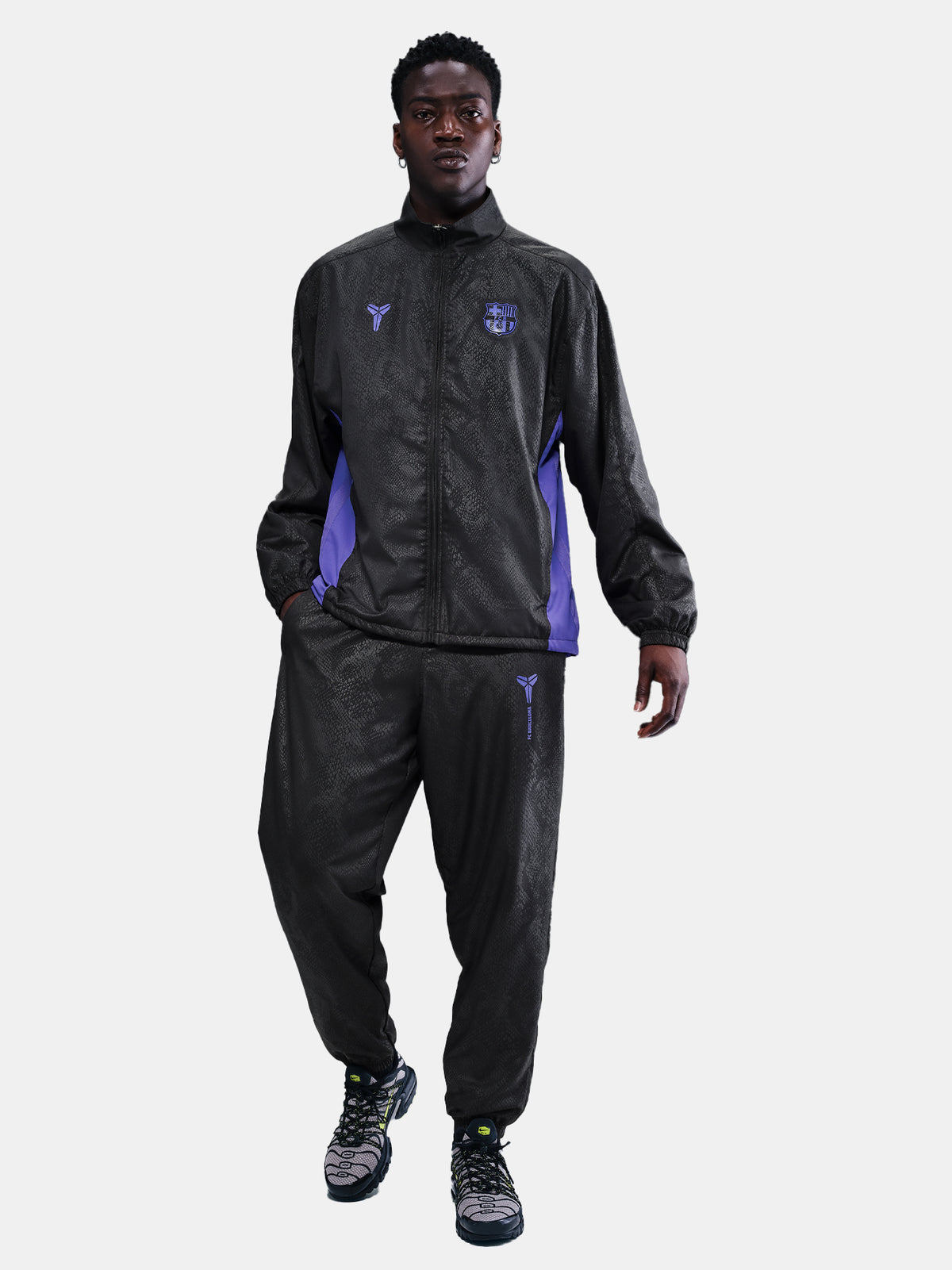 FC Barcelona black training pants with subtle textured pattern and light purple logo on the right thigh