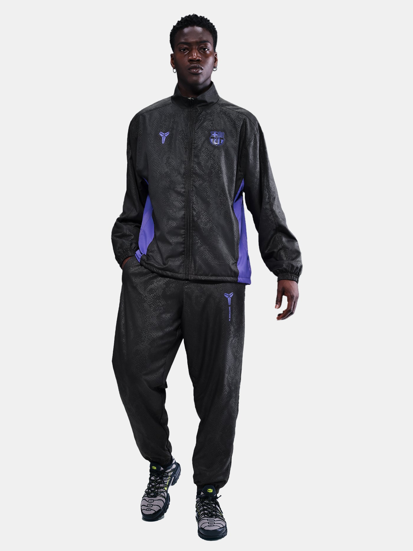 FC Barcelona black training pants with subtle textured pattern and light purple logo on the right thigh