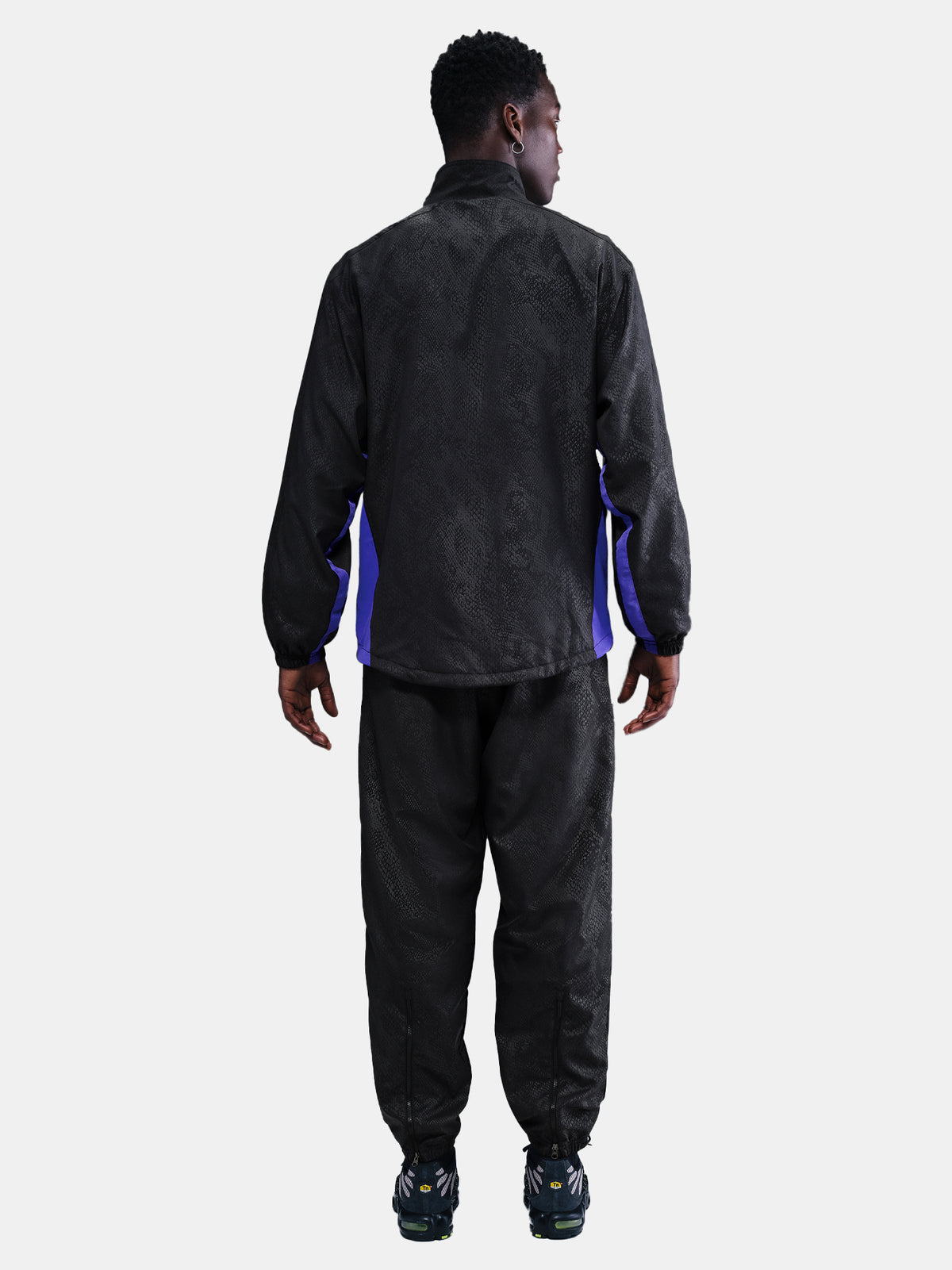 FC Barcelona black training pants with subtle textured pattern and light purple logo on the right thigh