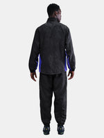 FC Barcelona black training pants with subtle textured pattern and light purple logo on the right thigh