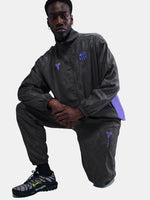 FC Barcelona black training pants with subtle textured pattern and light purple logo on the right thigh