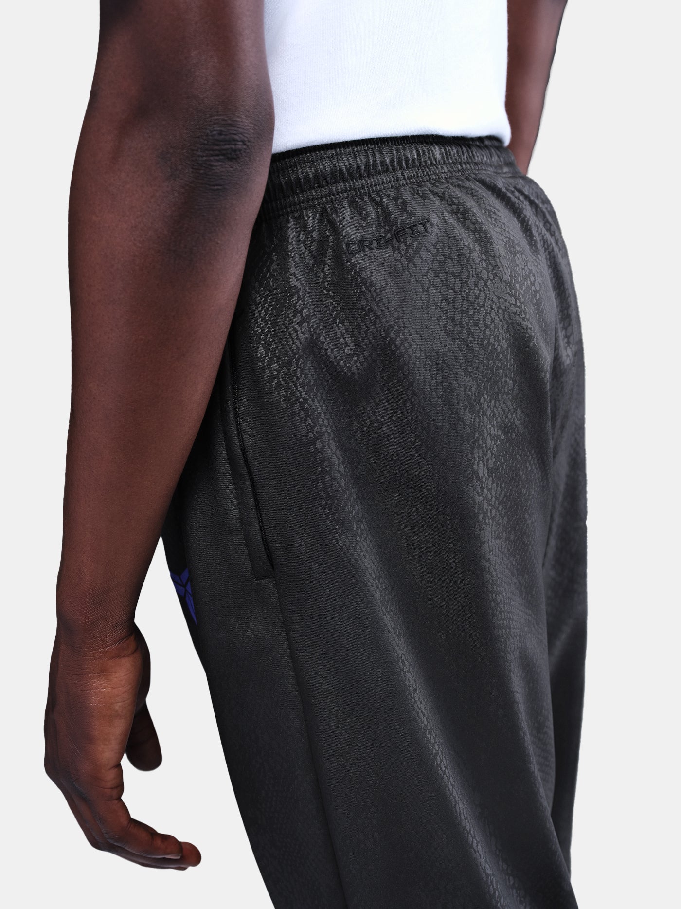 FC Barcelona black training pants with subtle textured pattern and light purple logo on the right thigh