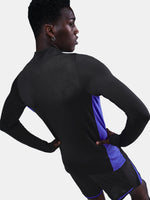 Black FC Barcelona training top with purple details, including the club crest, Nike logo, and Spotify sponsor logo, worn by a person.