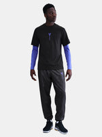 Black FC Barcelona T-shirt with blue Kobe Bryant logo on the chest, paired with black shorts featuring the same emblem.