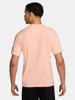Light pink FC Barcelona Nike t-shirt with short sleeves, featuring the club crest and Spotify sponsor on the chest