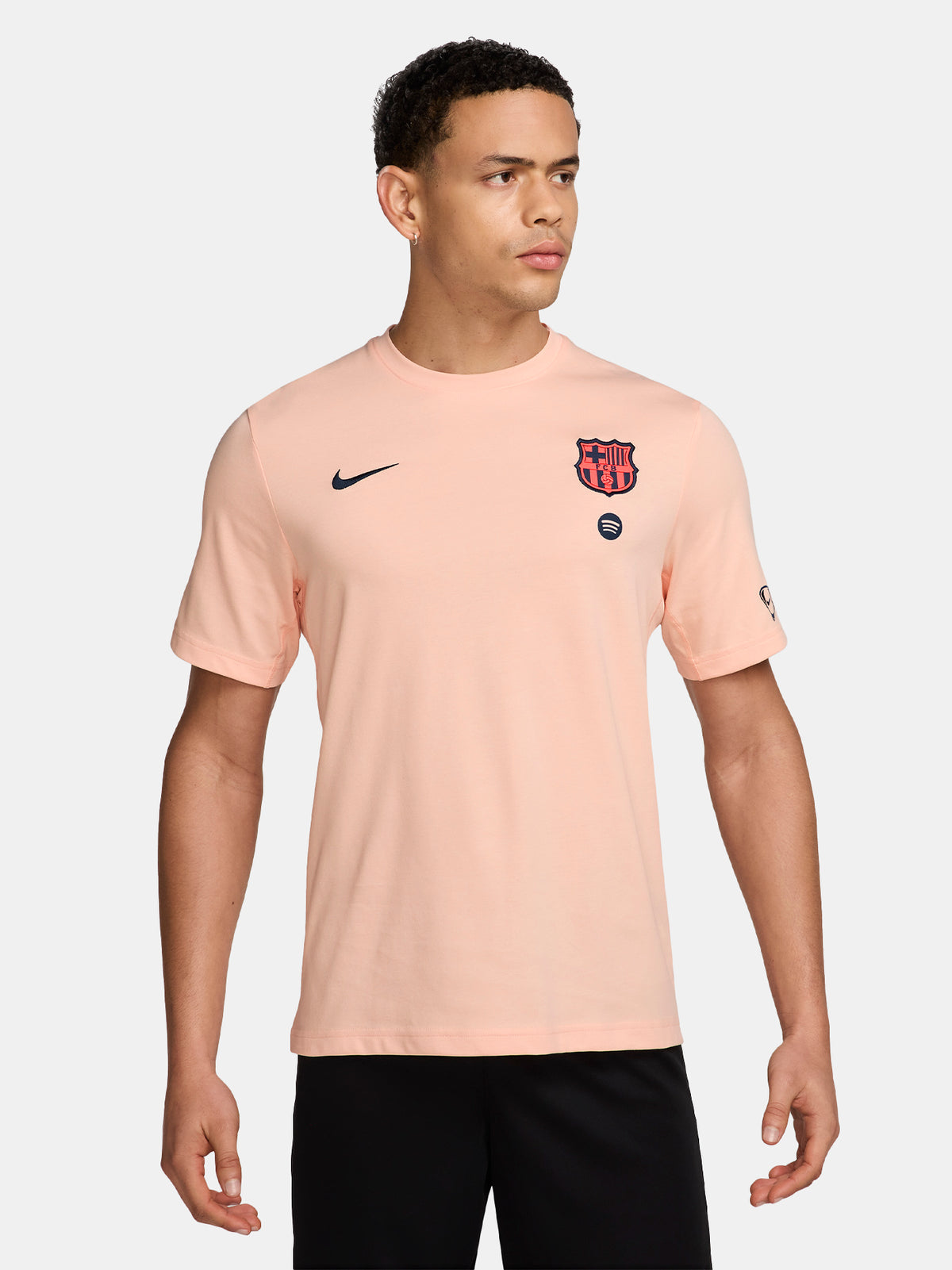 Light pink FC Barcelona Nike t-shirt with short sleeves, featuring the club crest and Spotify sponsor on the chest