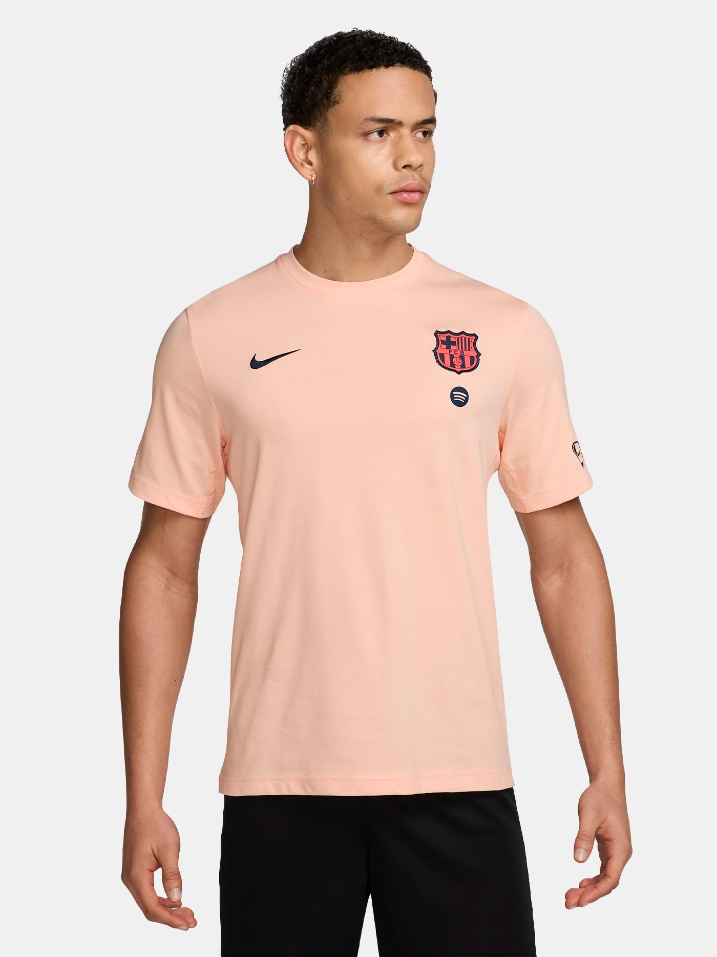 Light pink FC Barcelona Nike t-shirt with short sleeves, featuring the club crest and Spotify sponsor on the chest