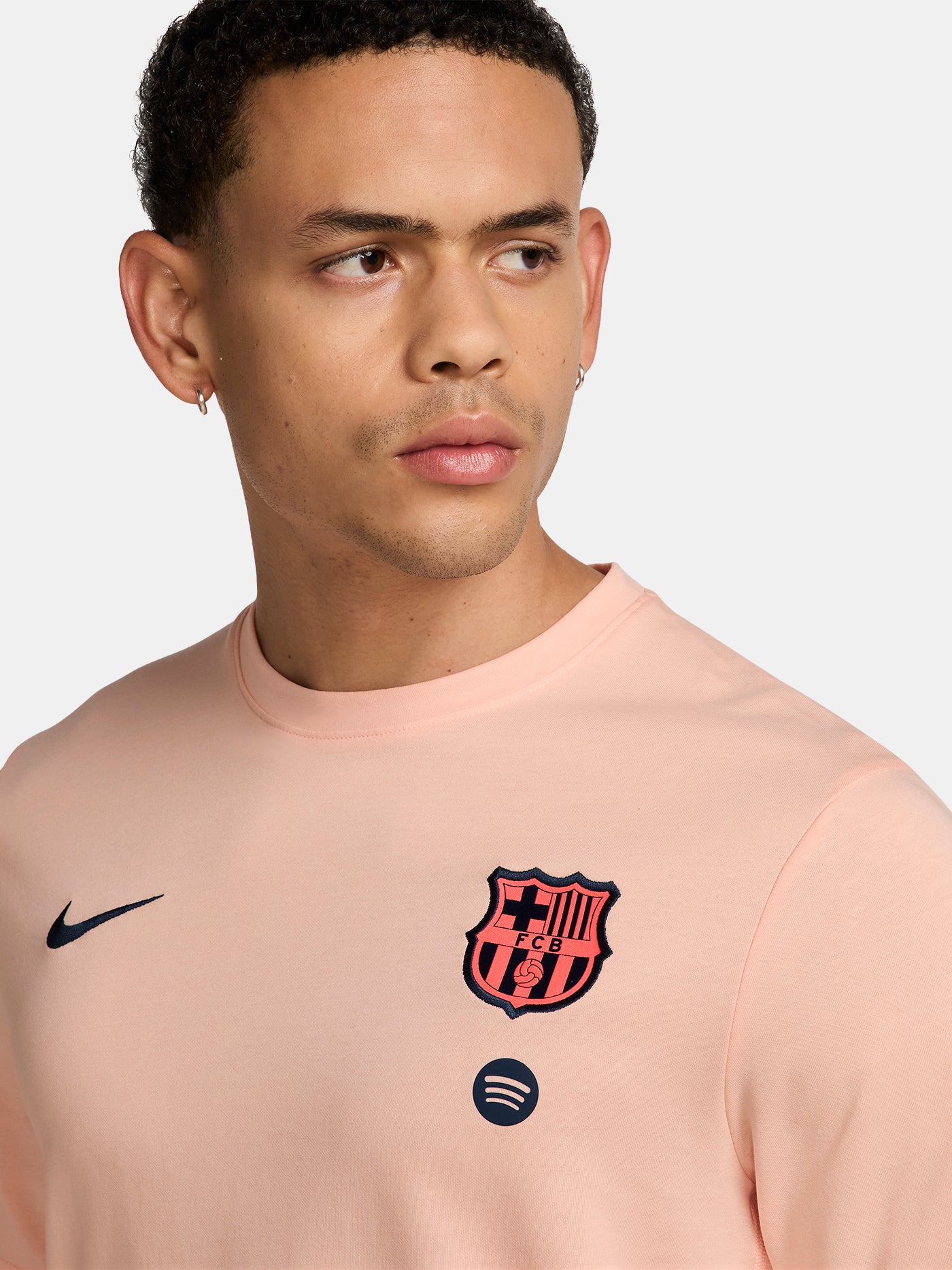 Light pink FC Barcelona Nike t-shirt with short sleeves, featuring the club crest and Spotify sponsor on the chest