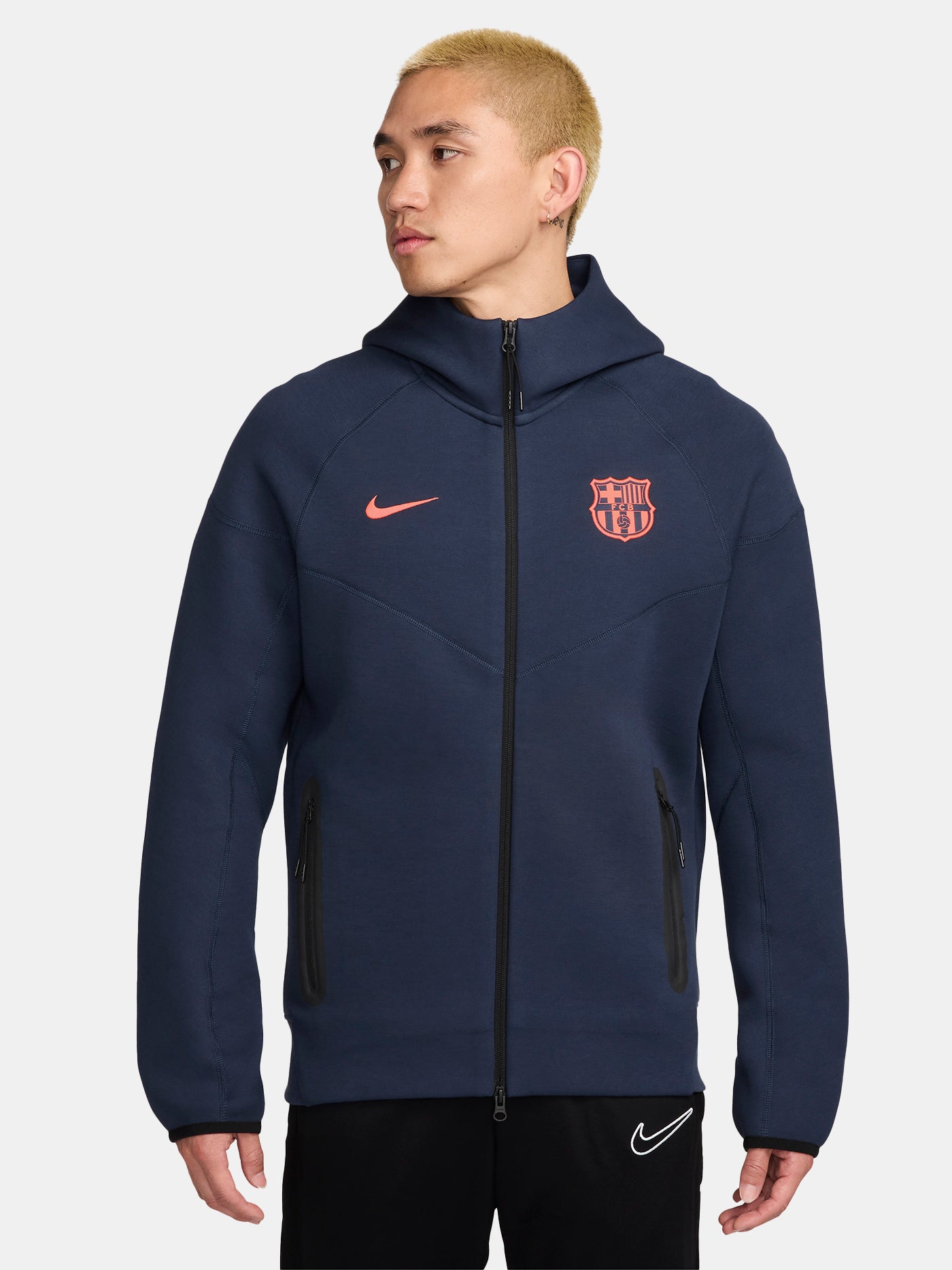 Navy FC Barcelona Nike zip-up hoodie featuring red crest and Nike swoosh on the chest.