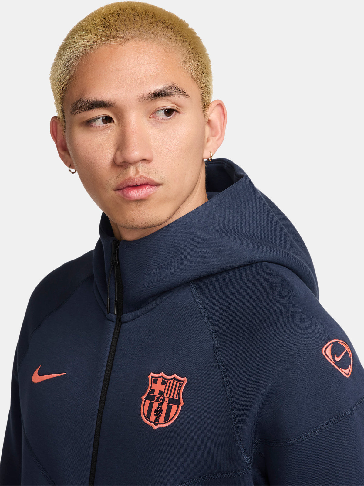 Navy FC Barcelona Nike zip-up hoodie featuring red crest and Nike swoosh on the chest.