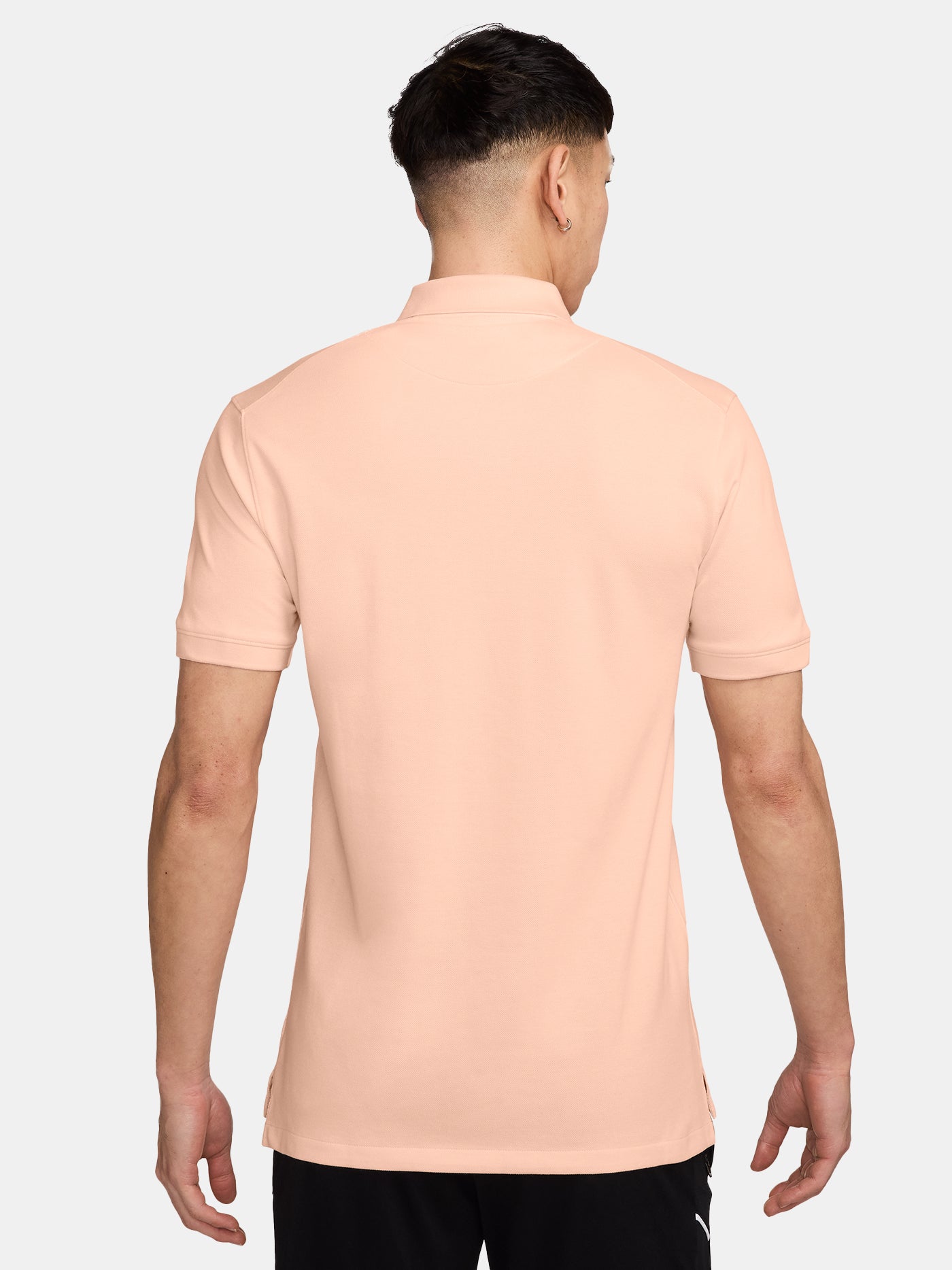 FC Barcelona light peach polo shirt with collar, featuring the club crest and Spotify logo on the chest alongside the Nike swoosh in navy