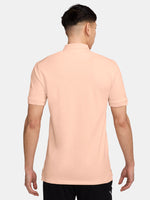 FC Barcelona light peach polo shirt with collar, featuring the club crest and Spotify logo on the chest alongside the Nike swoosh in navy