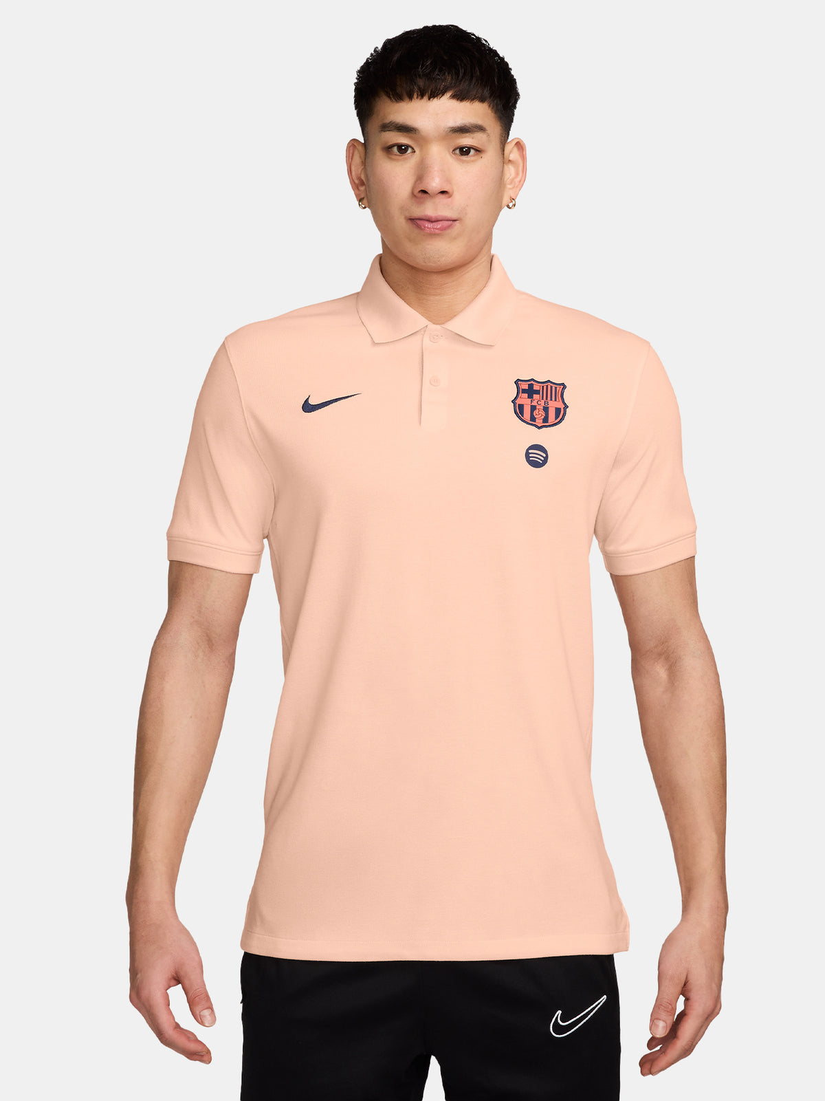 FC Barcelona light peach polo shirt with collar, featuring the club crest and Spotify logo on the chest alongside the Nike swoosh in navy