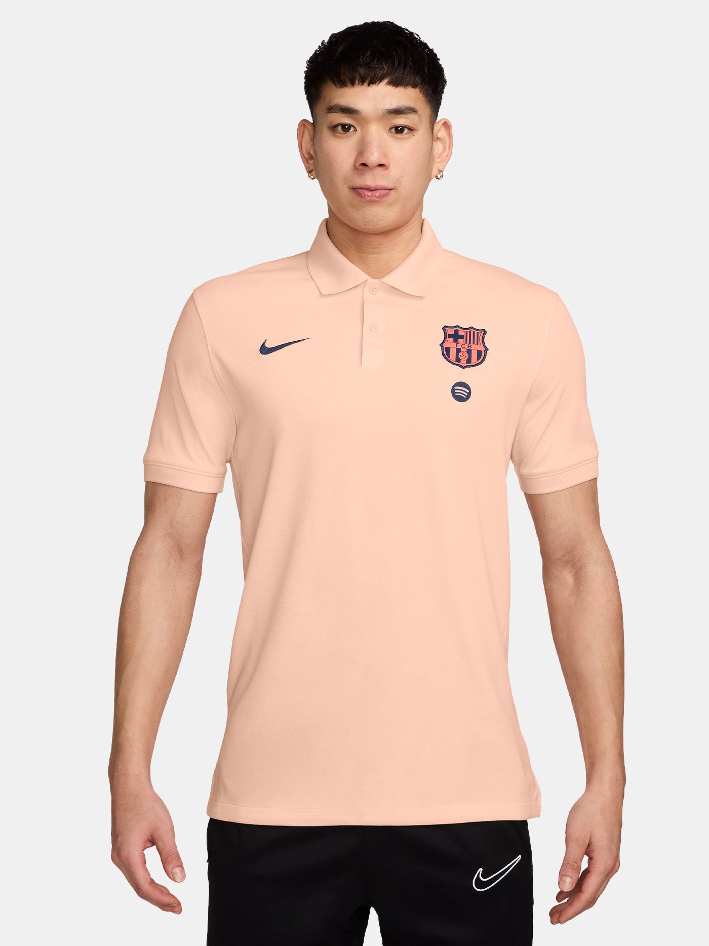 FC Barcelona light peach polo shirt with collar, featuring the club crest and Spotify logo on the chest alongside the Nike swoosh in navy