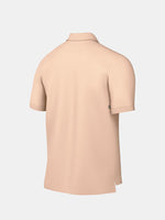 FC Barcelona light peach polo shirt with collar, featuring the club crest and Spotify logo on the chest alongside the Nike swoosh in navy