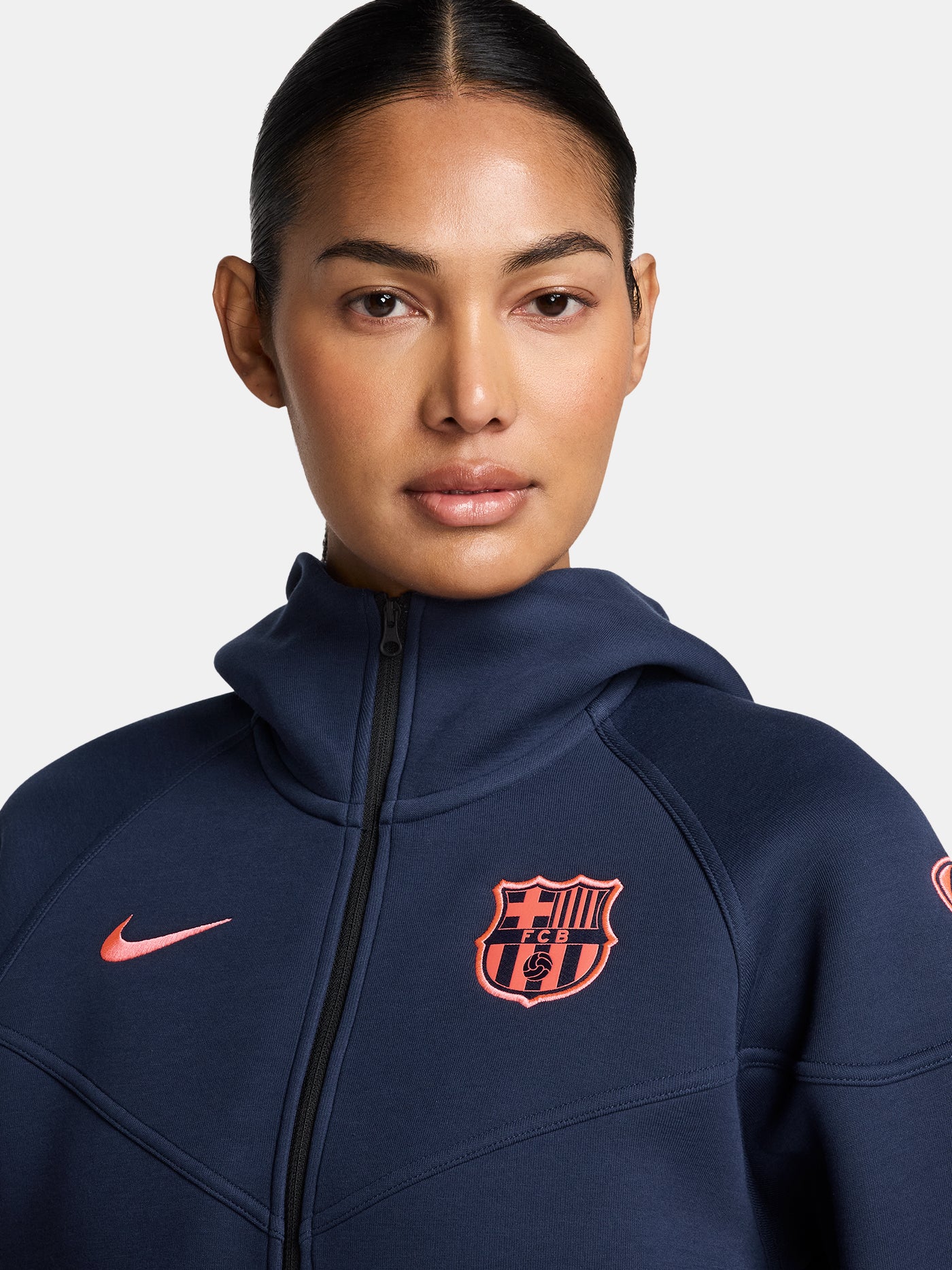 Navy FC Barcelona Nike zip-up hoodie featuring red crest and Nike swoosh on the chest.