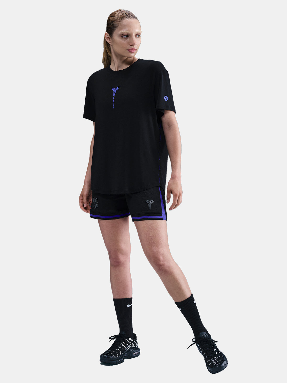 Black FC Barcelona T-shirt with blue Kobe Bryant logo on the chest, paired with black shorts featuring the same emblem.