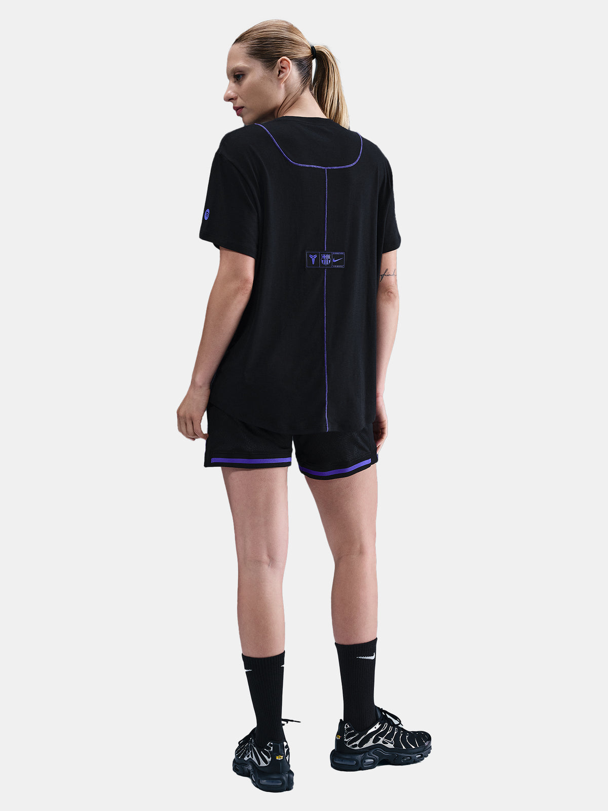 Black FC Barcelona T-shirt with blue Kobe Bryant logo on the chest, paired with black shorts featuring the same emblem.