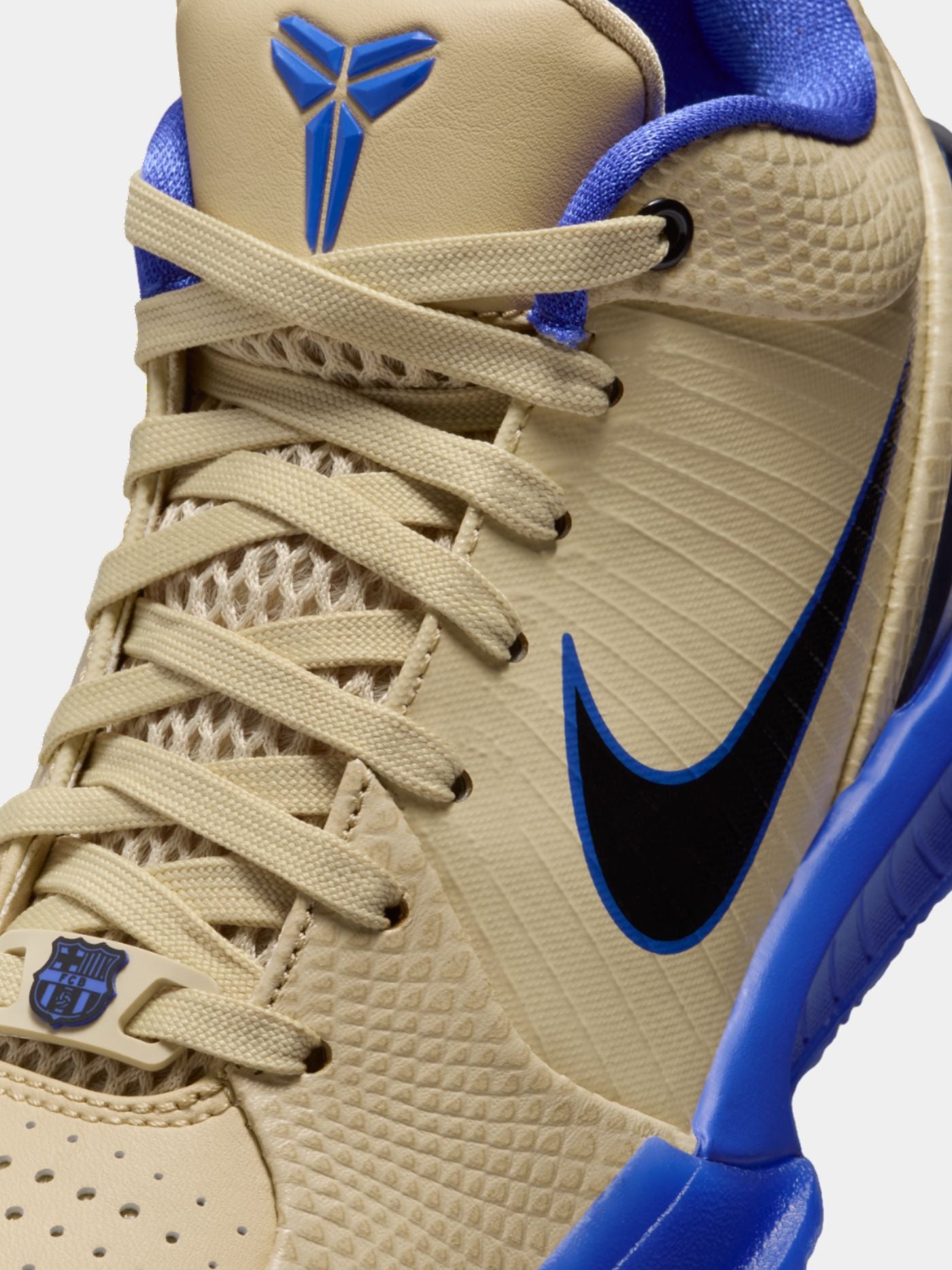 Beige and blue sneaker with Nike logo on a light gray background