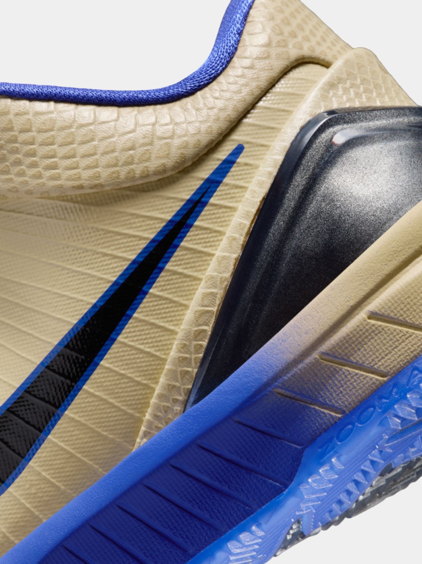 Close-up of a sneaker with blue and black accents on a white background