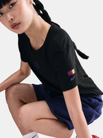 Black FC Barcelona Nike t-shirt with blue Barça crest on the chest, worn casually with blue pants and a black shoulder bag